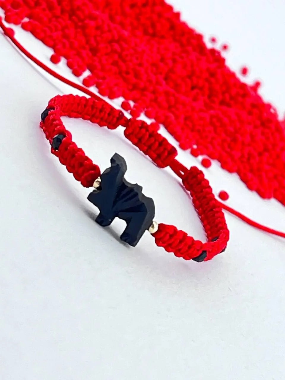 - Pulsera para niños en tejido macarme c elefante de azabache y balines de oro 14k